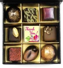 34 36. Black gift box with 9 chocolates and Thank you! message.